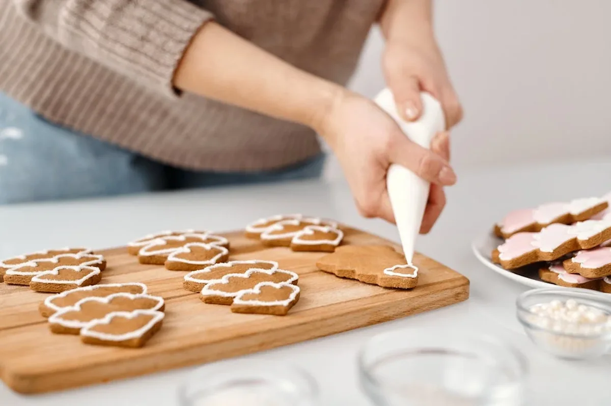 A woman making cookies, lit with soft natural light